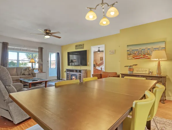 a living room with dining table and chairs