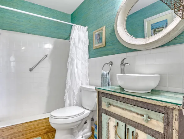 a bathroom with a toilet a sink and a mirror