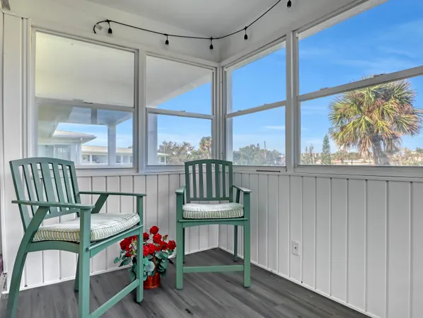 a balcony with furniture and a potted plant
