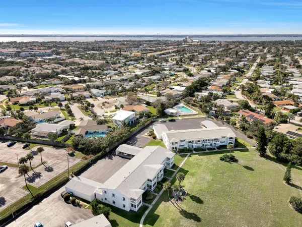 an aerial view of residential houses with yard