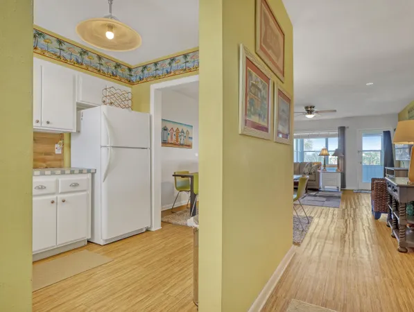 a view of a livingroom with furniture wooden floor a chandelier