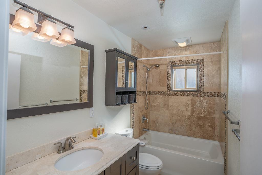 532 Monterey Road Pacifica, CA 94044 - Photo 15 of 41 a bathroom with a sink vanity granite tub shower and a mirror