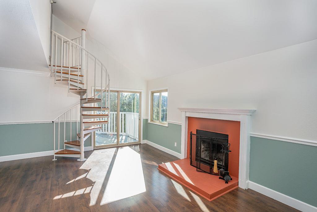 532 Monterey Road Pacifica, CA 94044 - Photo 20 of 41 a living room with wooden floor and a fireplace