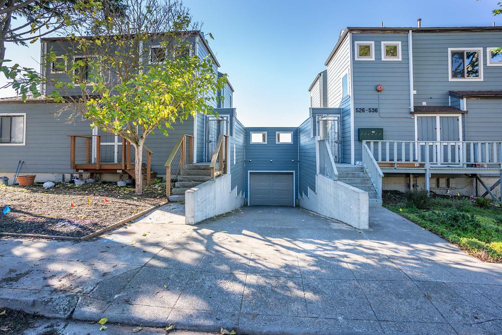532 Monterey Road Pacifica, CA 94044 - Photo 24 of 41 a front view of a house with a yard and garage
