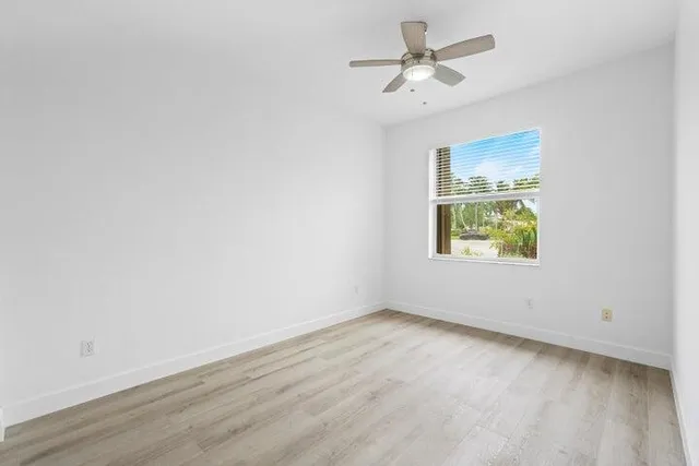 a bathroom with a granite countertop sink and white cabinets