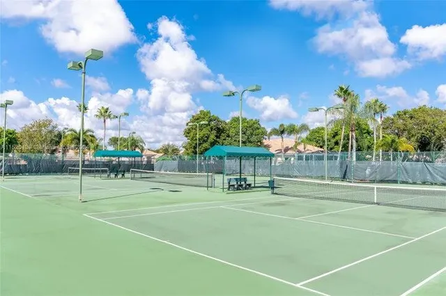 an aerial view of a house with swimming pool and garden