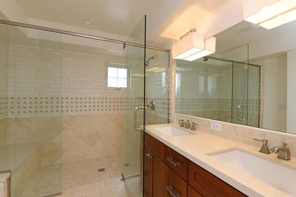 a bathroom with a shower sink and mirror