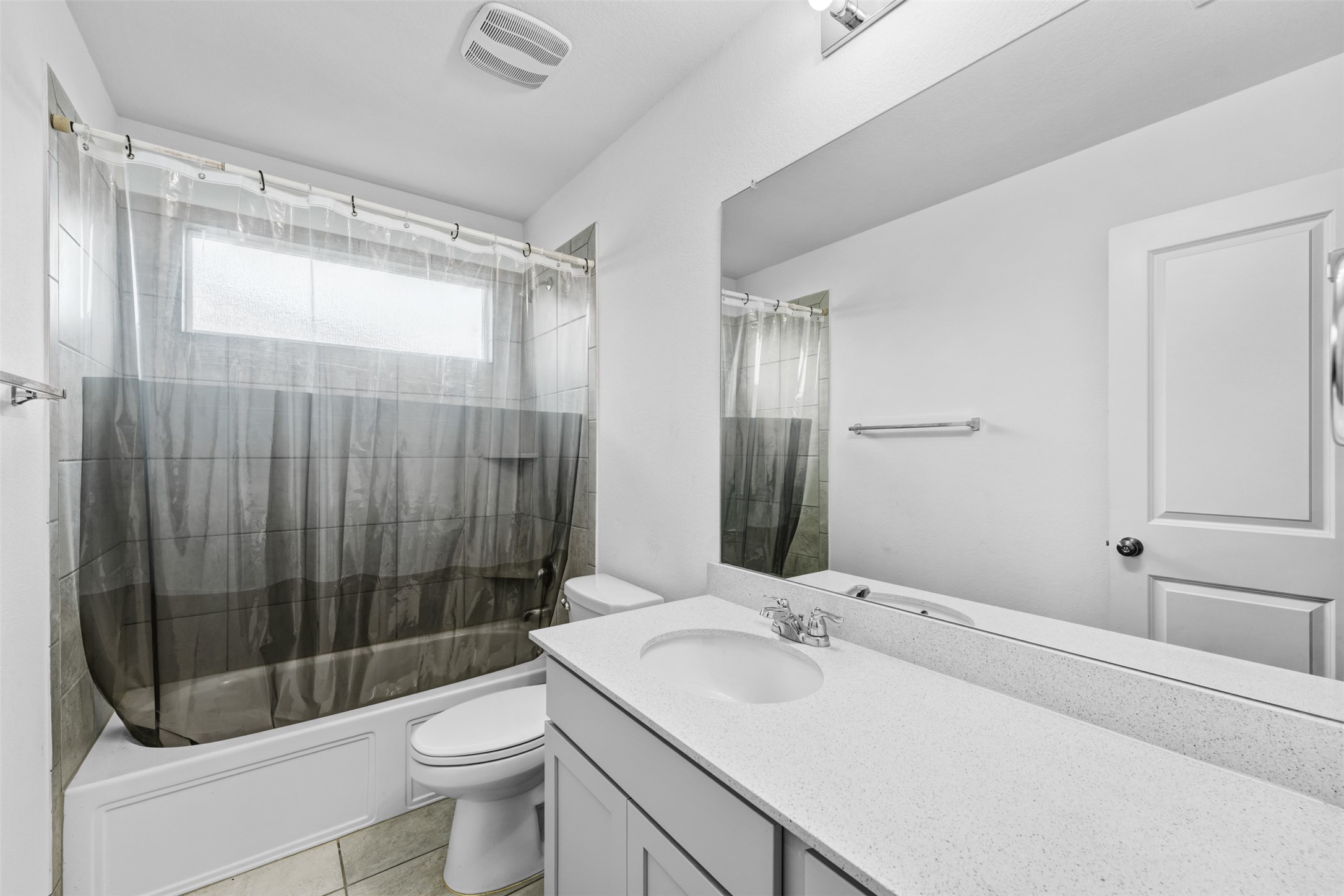 413 Perfect World Loop Jarrell, TX 76537 - Photo 27 of 39 A well-lit guest bath provides a shower-tub combo and single vanity with ample counter space.