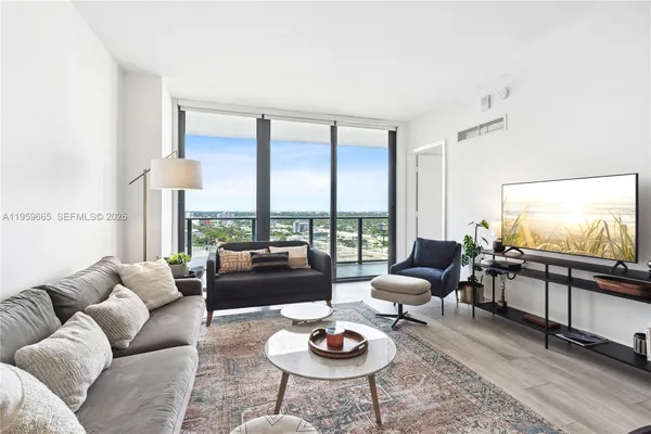 a living room with furniture and a large window