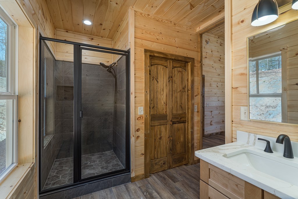 304 Old Evans Road Murphy, NC 28906 - Photo 16 of 31 a bathroom with a shower sink and mirror
