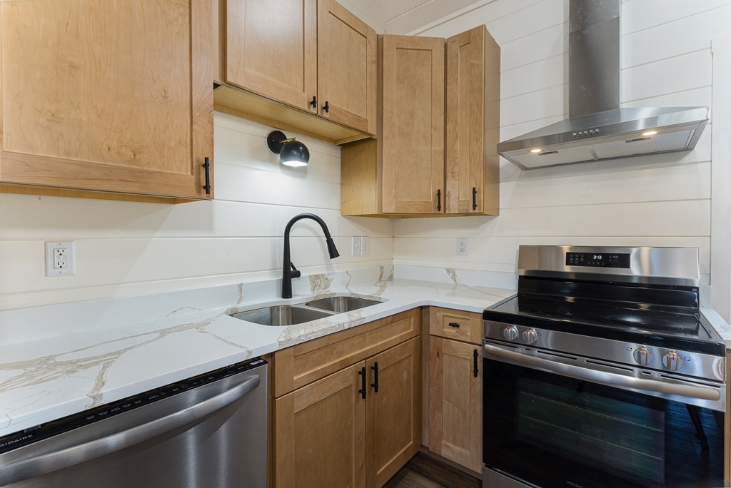 304 Old Evans Road Murphy, NC 28906 - Photo 28 of 31 a kitchen with stainless steel appliances granite countertop a sink stove and cabinets