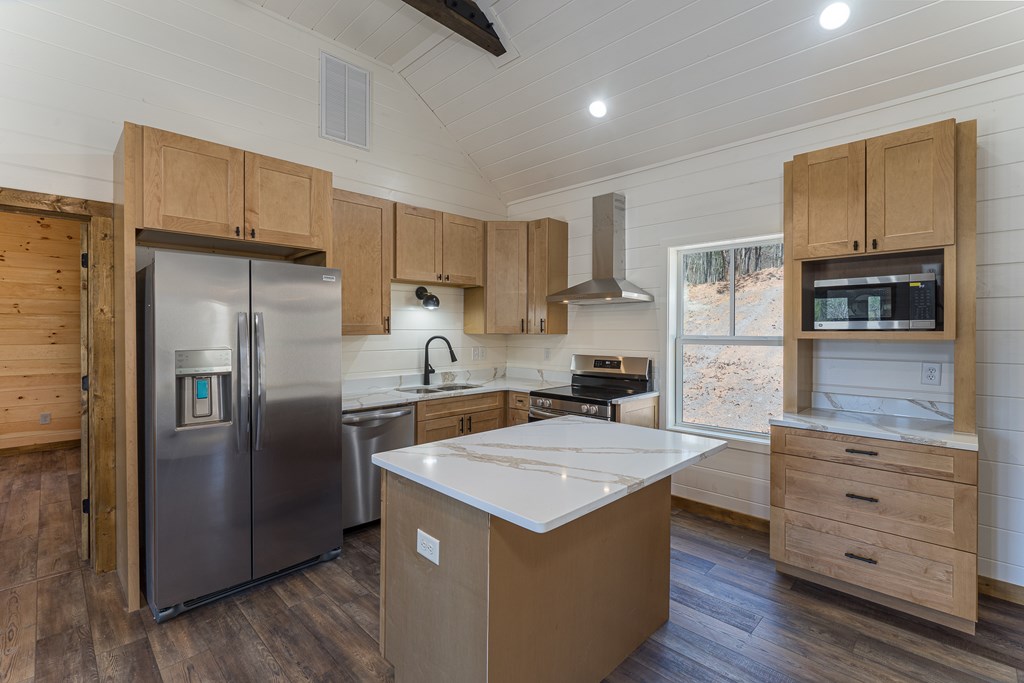 304 Old Evans Road Murphy, NC 28906 - Photo 29 of 31 a kitchen with a refrigerator a sink and wooden cabinets