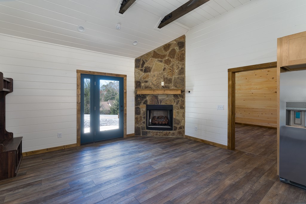 304 Old Evans Road Murphy, NC 28906 - Photo 9 of 31 a view of an empty room with wooden floor and a fireplace