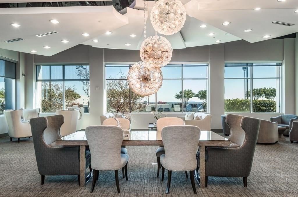 250 Pharr Road Northeast, Unit 601 Atlanta, GA 30305 - Photo 29 of 34 a dining room with furniture a large window and a chandelier
