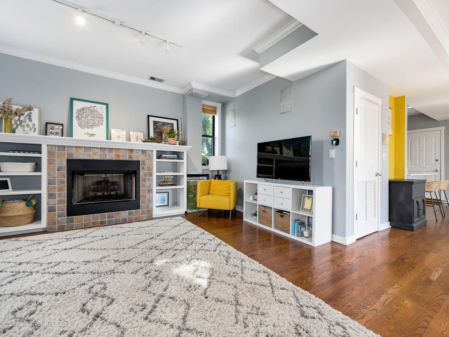 2075 North Oakley Avenue, Unit 3F Chicago, IL 60647 - Photo 13 of 24 a living room with a flat screen tv and a fireplace