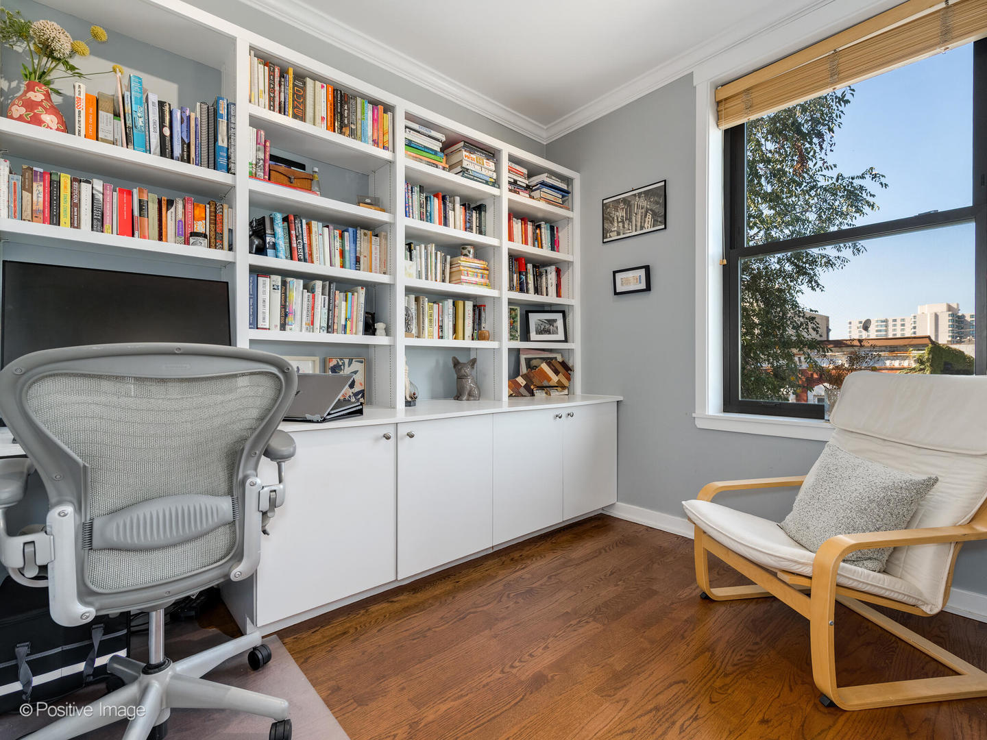 2075 North Oakley Avenue, Unit 3F Chicago, IL 60647 - Photo 14 of 24 a room with a workspace and a book shelf