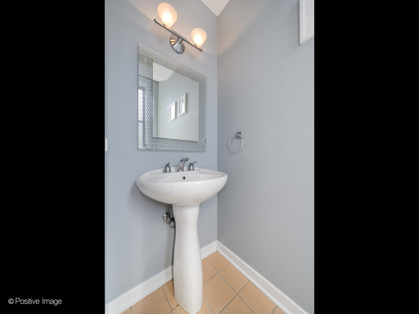 2075 North Oakley Avenue, Unit 3F Chicago, IL 60647 - Photo 15 of 24 a view of a bathroom with a sink and mirror