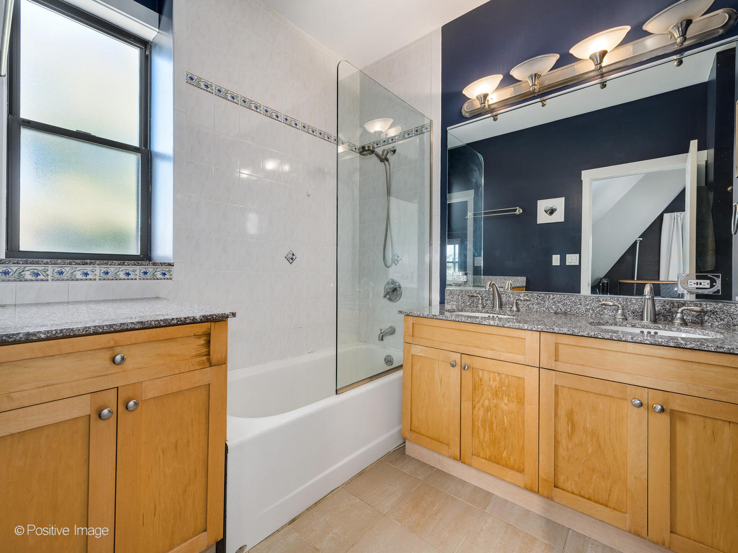 2075 North Oakley Avenue, Unit 3F Chicago, IL 60647 - Photo 21 of 24 a bathroom with a sink a large mirror and a bathtub