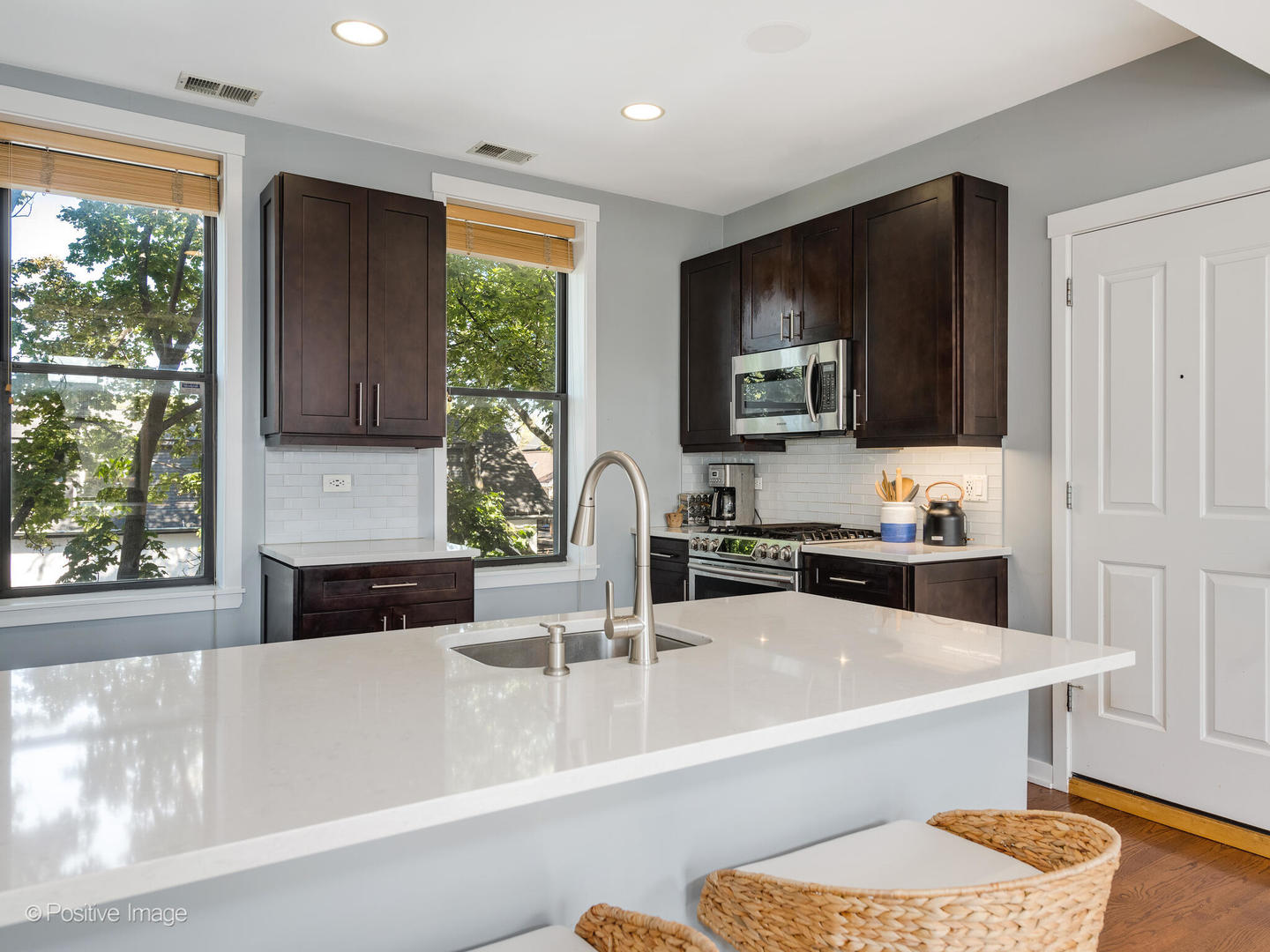 2075 North Oakley Avenue, Unit 3F Chicago, IL 60647 - Photo 4 of 24 a kitchen with a stove a sink and a microwave