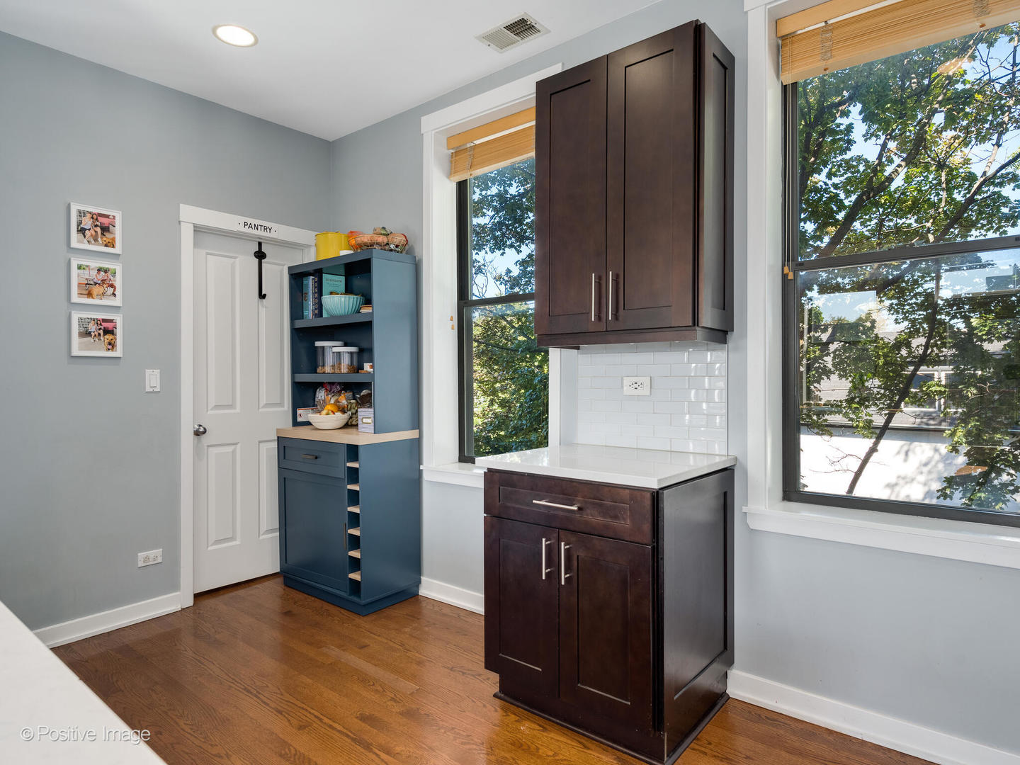 2075 North Oakley Avenue, Unit 3F Chicago, IL 60647 - Photo 5 of 24 a view of cabinets with window and hardwood