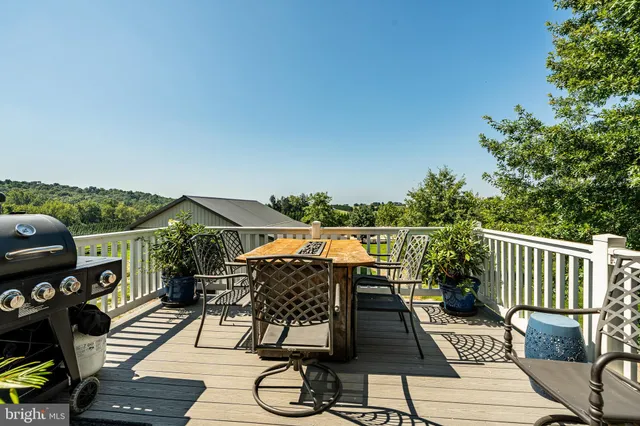 a view of a balcony with wooden floor and outdoor seating