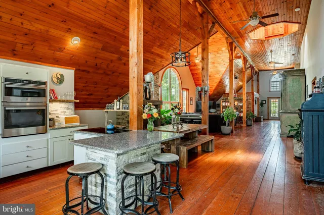a view of a kitchen with dining table and chairs