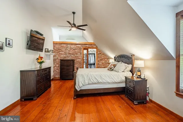 a spacious bedroom with a bed and a fireplace