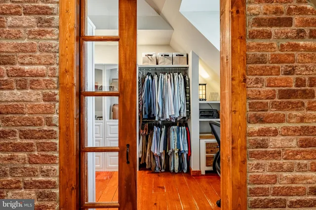 walk in closet with wooden floor