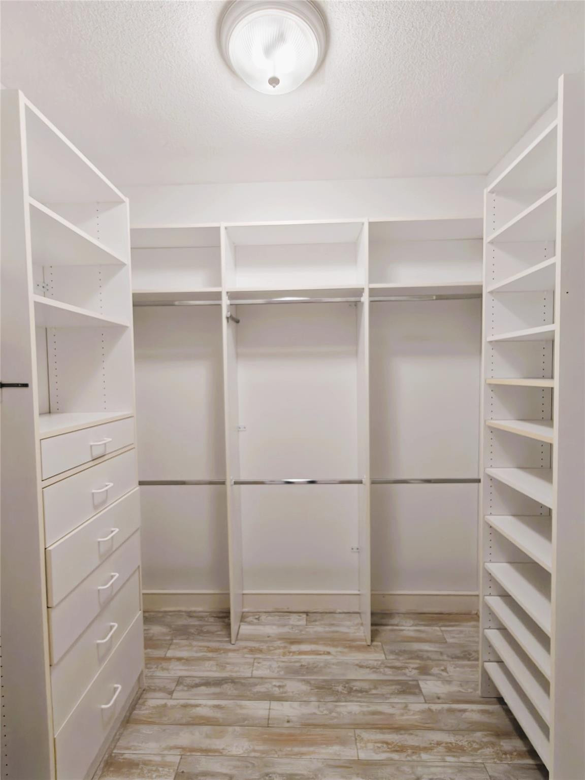 2939 Paddock Lane Weston, FL 33331 - Photo 32 of 86 a view of walk in closet with empty racks