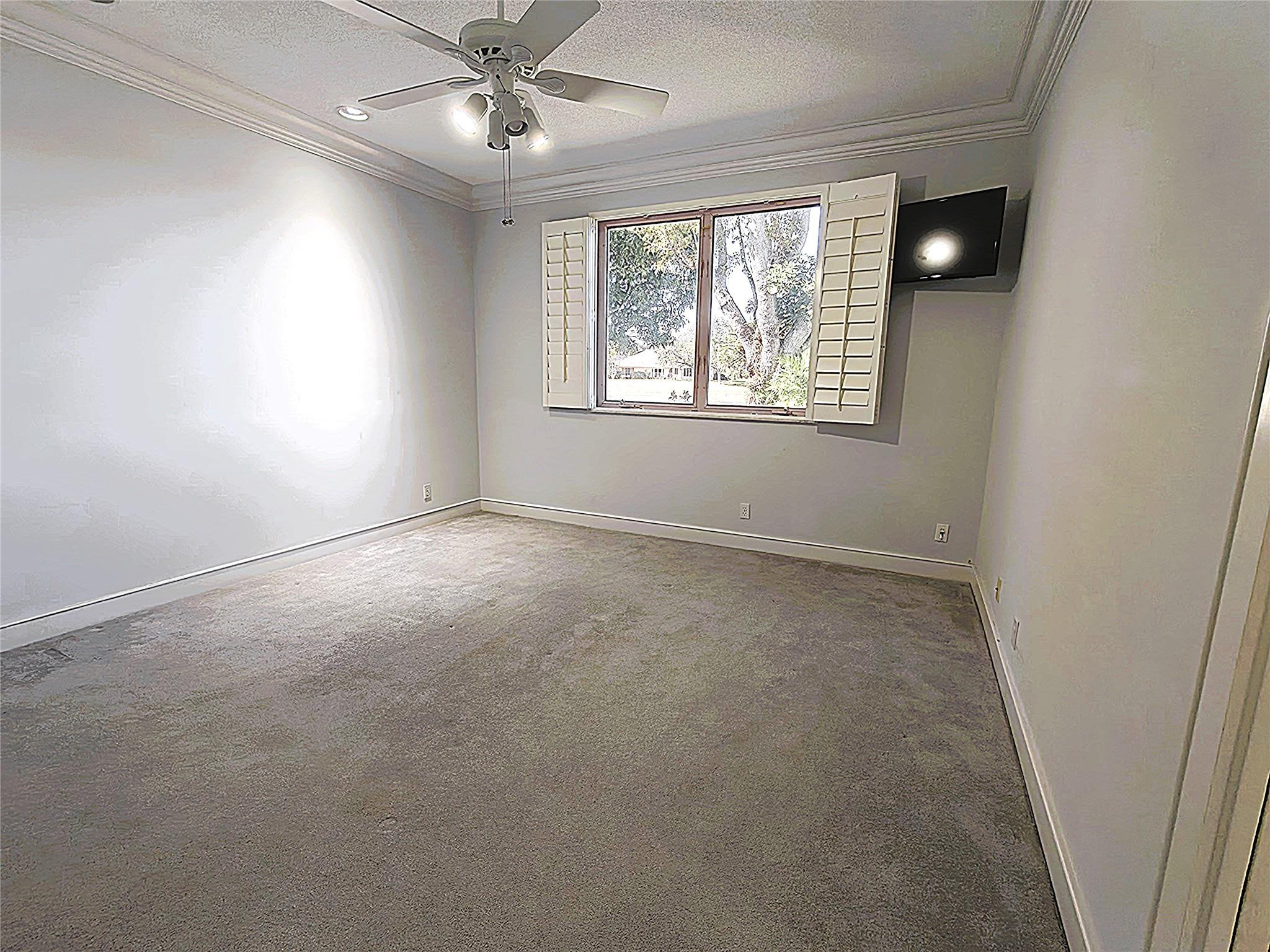 2939 Paddock Lane Weston, FL 33331 - Photo 43 of 86 an empty room with windows and chandelier fan