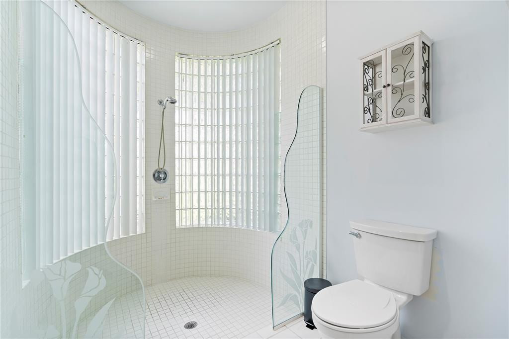 2939 Paddock Lane Weston, FL 33331 - Photo 54 of 86 a white toilet sitting next to a bathroom sink