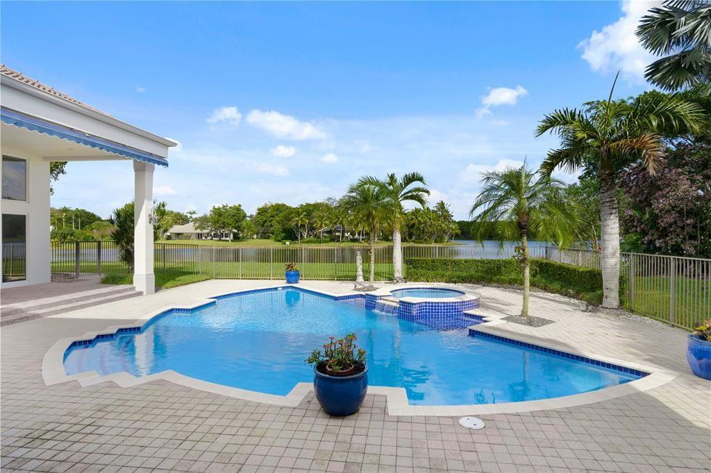 2939 Paddock Lane Weston, FL 33331 - Photo 68 of 86 a view of a swimming pool with a patio