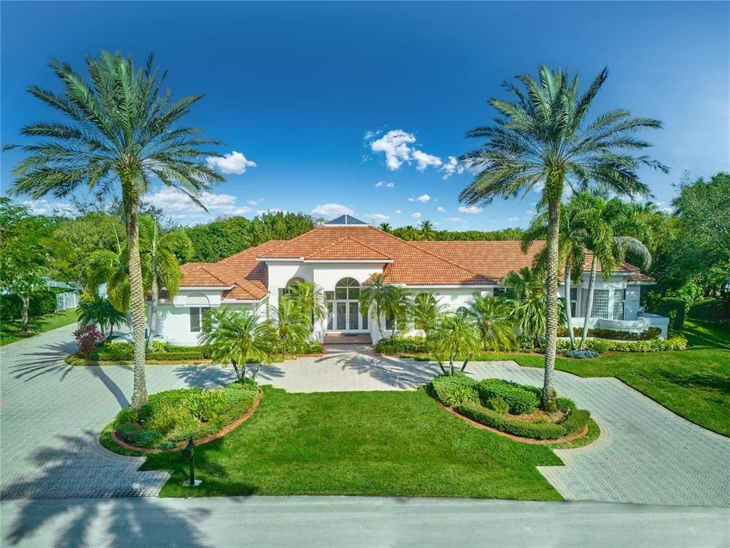 2939 Paddock Lane Weston, FL 33331 - Photo 71 of 86 a view of a house with a yard and potted plants
