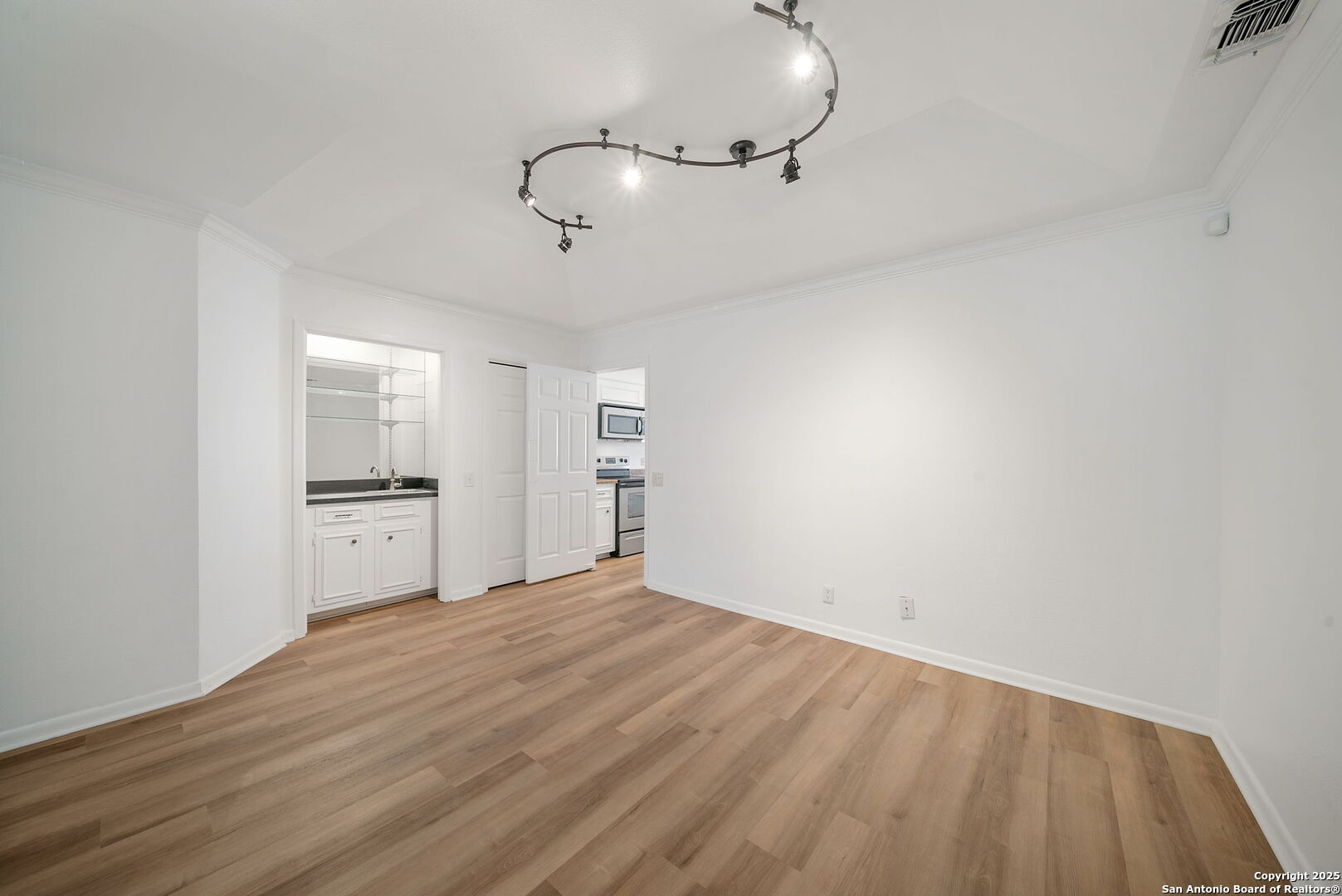 8415 Fredericksburg Road, Unit 704 San Antonio, TX 78229 - Photo 12 of 30 a view of a kitchen with a sink and dishwasher a refrigerator with wooden floor
