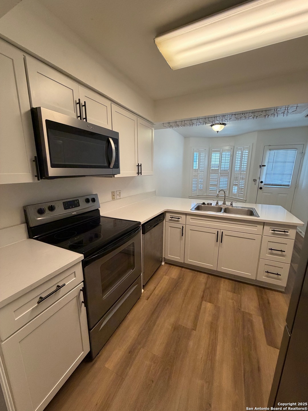 8415 Fredericksburg Road, Unit 704 San Antonio, TX 78229 - Photo 17 of 30 a kitchen with kitchen island a sink stainless steel appliances and cabinets