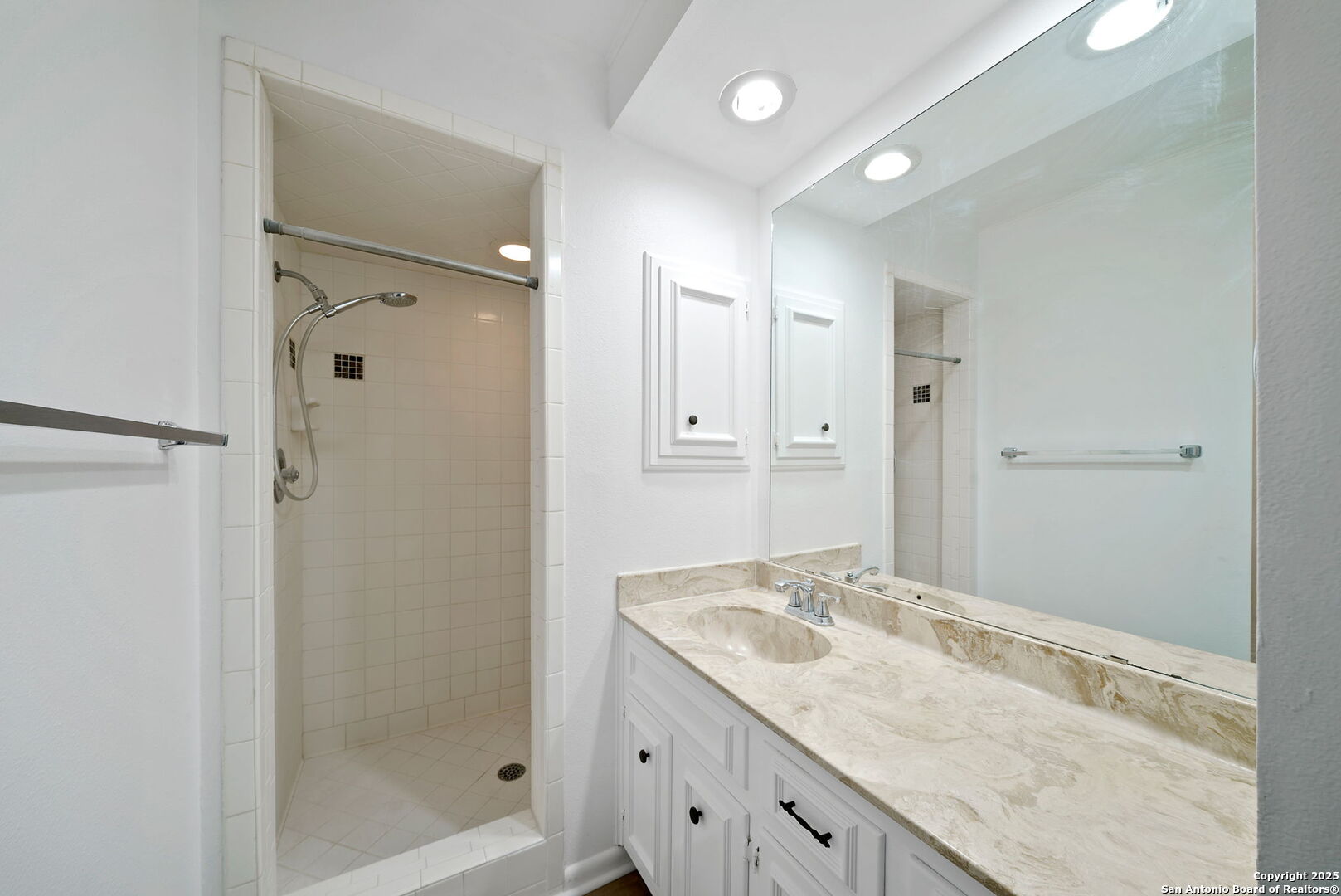 8415 Fredericksburg Road, Unit 704 San Antonio, TX 78229 - Photo 25 of 30 a bathroom with a granite countertop sink mirror and shower