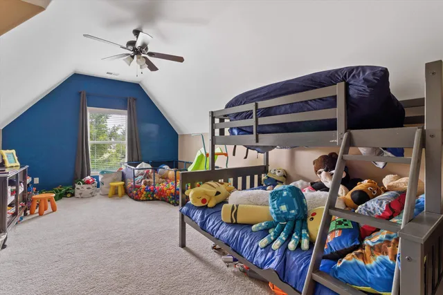 a bedroom with furniture and a ceiling fan
