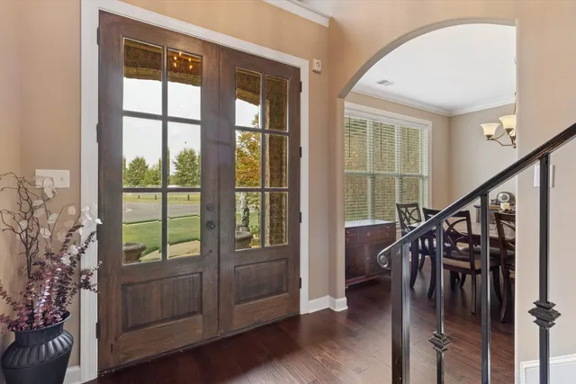 a view of entryway and hall with wooden floor