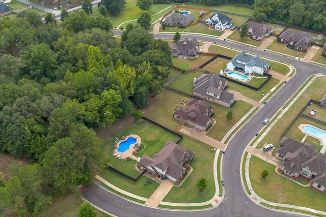 an aerial view of a house with a yard basket ball court and outdoor seating