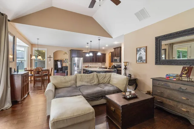 a living room with furniture and wooden floor