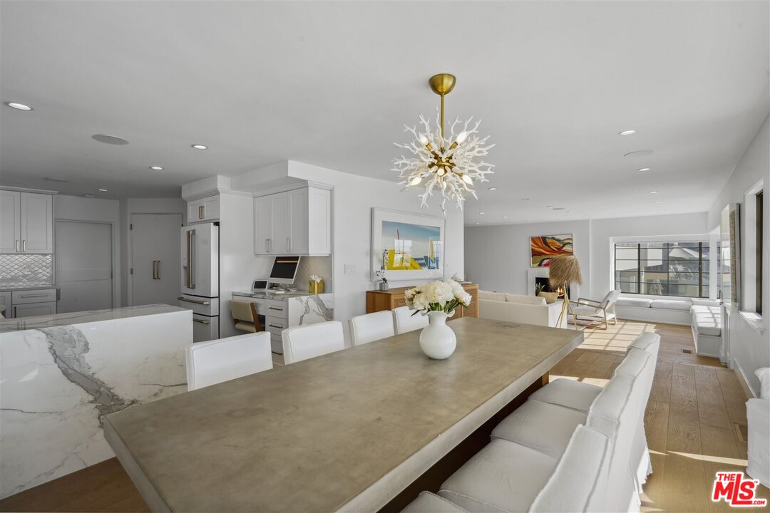 31500 Victoria Point Road Malibu, CA 90265 - Photo 12 of 53 a dining room with wooden floor and chandelier