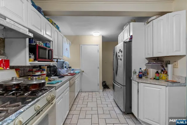 a kitchen with stainless steel appliances granite countertop a sink and cabinets