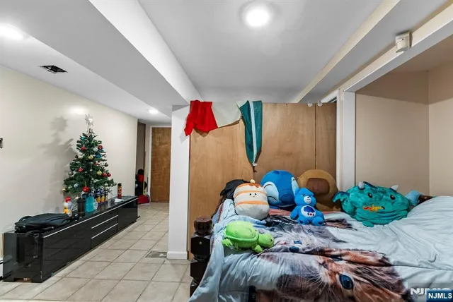 a bedroom with baby crib and wooden floor