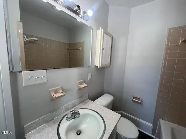a bathroom with a sink toilet and vanity
