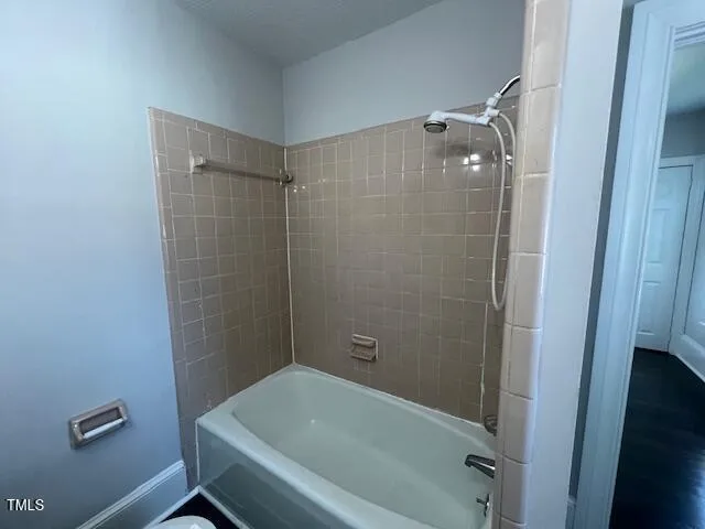 a bathroom with a tub and shower