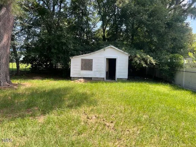 a front view of a house with yard and green space