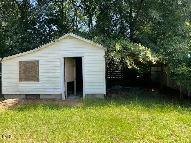 a view of house with backyard and garden