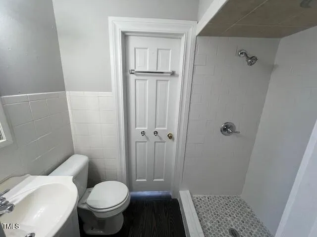 a bathroom with a toilet and a shower