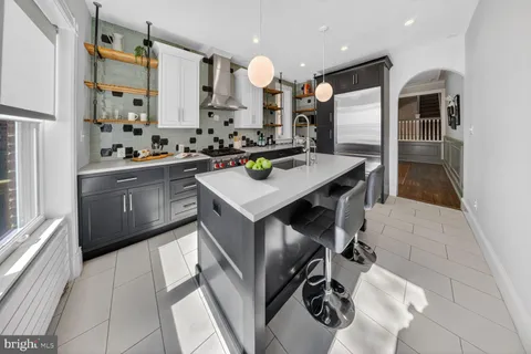 a dining room with furniture a chandelier and wooden floor