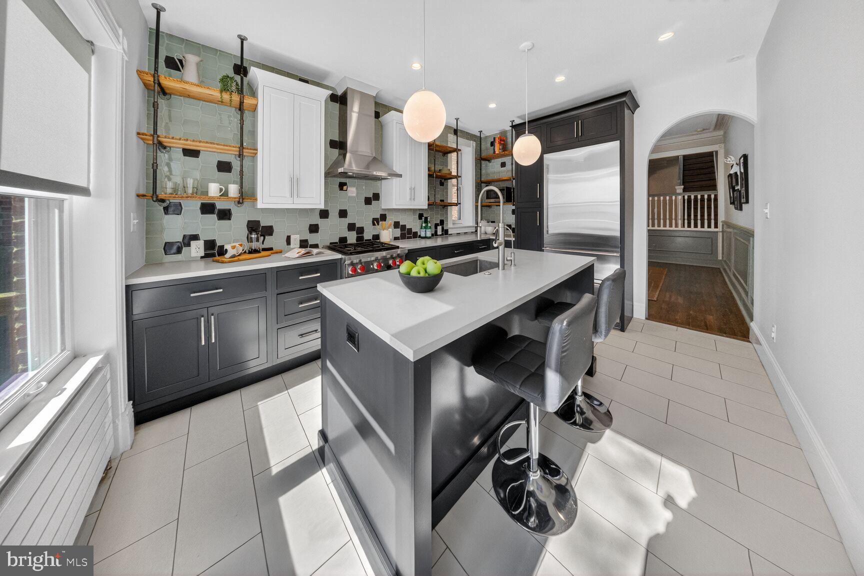 216 N Street Northwest Washington, DC 20001 - Photo 11 of 30 a kitchen with kitchen island stainless steel appliances a sink stove and refrigerator
